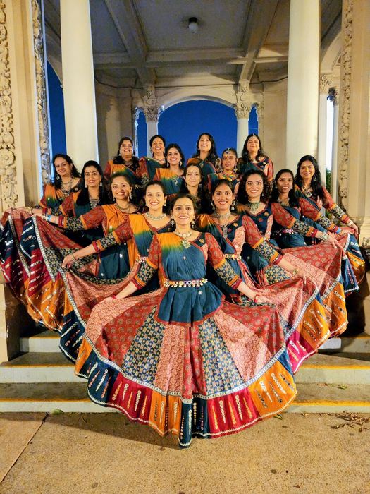 Large group with skirts fanned out at an evening performance